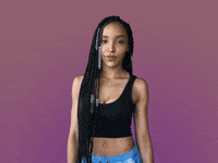 Celebrity gif. Tinashe rolls her eyes and holds her hands up to make a big W as she says, “Whatever.”