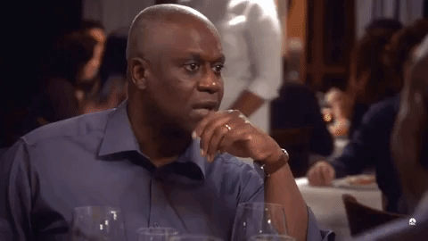TV gif. In a scene from "Brooklyn Nine-Nine," Andre Braugher as Captain Ray Holt sits upright at a restaurant table. Looking around and raising his eyebrows, he says, "Oh my goodness, I am very intoxicated," which appears as text.
