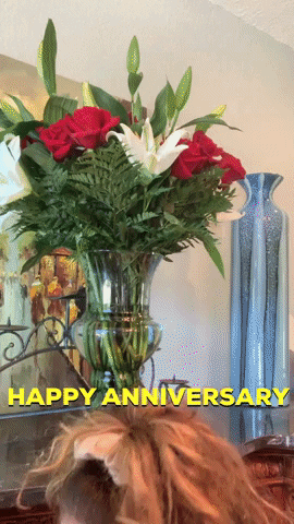 Video gif. Woman pops up holding a peeled banana and gives us a huge grin and double thumbs up. Text, "Happy Anniversary!"