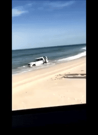 Man Shovels to Save SUV From Waves on New Jersey Beach