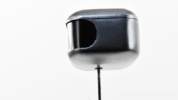Video gif. Robot head turns to us and narrows its digital eyes in suspicion.