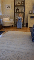 Inspired by Olympics, Little Girl in Princess Dress Attempts Living Room Gymnastics