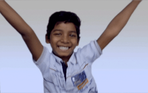 Celebrity gif. Sunny Pawar pumps his arms up and dances with a big grin on his face. 