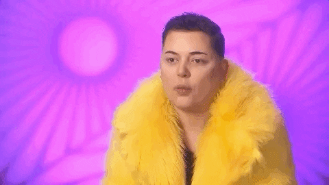 Reality TV gif. A contestant from Drag Race UK looks at us in disbelief as their head drops down in shock.