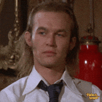Movie gif. Blond-haired guy in "Cleopatra Jones" looks blank and rolls his eyes.