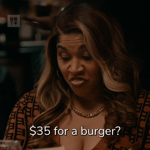 TV gif. Claudia Logan as Moni in Diarra from Detroit furrows her brow as she looks at a menu and speaks emphatically, saying, "35 dollars for a burger?"