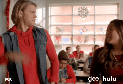 TV gif. Chord Overstreet as Sam Evans and Jenna Ushkowitz as Tina Cohen-Chang in Glee high five and clasp their hands together.
