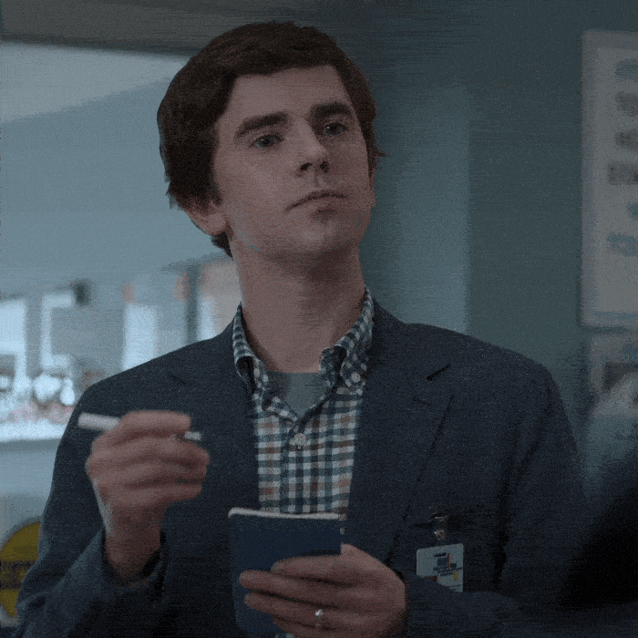 TV gif. Freddie Highmore as Dr. Shaun Murphy on The Good Doctor. He holds a pen in his hand and a notebook in the other and he pauses, thinking about new information he's heard, then writes it down in the notebook.