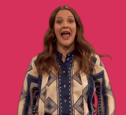 Celebrity gif. Wide-eyed and super excited Drew Barrymore waves her arms in front of her with her mouth wide open.