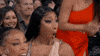 Celebrity gif. Megan Thee Stallion at the Billboard Music Awards 2022 looking honestly shocked while those around her gas her up and clap. 