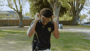 TV gif. Juhahn Jones as Randall on Burb Patrol raises his hands above his head and then drops them on his hips as if exhausted. 