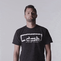 Video gif. A man stares at us with a frightened expression. He points to his left and moves his pointer finger to emphasis that we should look that way. 