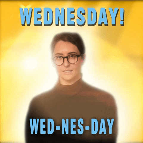 Video gif. Woman wearing glasses and a turtleneck surrounded by an angelic glow against a bright yellow background. Text reads, "Wednesday! Wed-nes-day."