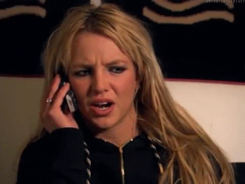 Celebrity gif. Britney Spears holds a cell phone up to her ear. She has a concerned look on her face as she listens to the other person on the phone. She then goes, “ohhh," now understanding what was said to her.