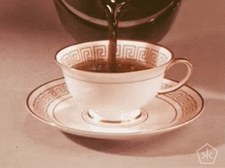 Video gif. Coffee is being poured into a matching coffee and saucer set, the coffee flowing endlessly.