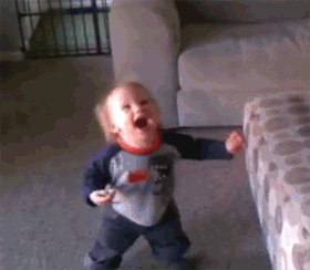 Video gif. Happy dancing baby opens his mouth wide in excitement as bubbles float down around him.