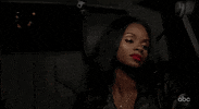 Reality TV gif. Natasha Parker from The Bachelor sits in the backseat of a car on a night drive, looking tired and disappointed as she stares out the window.