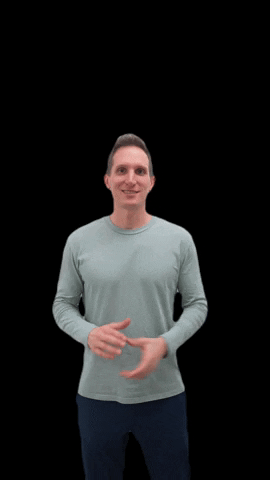 Video gif. A man in a gray long sleeve shirt and dark blue sweatpants stands in front of a black background. He clasps his hands together and shakes them towards the sky on each side with a smile on his face. 