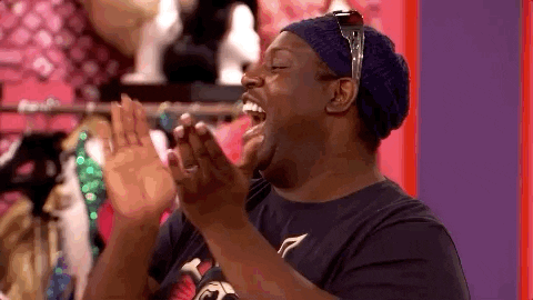 Reality TV gif. Latrice Royale and Trinity the Tuck on RuPaul’s Drag Race All Stars turn towards each other and high five, grinning in excitement.