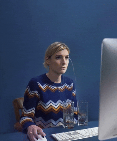 Video gif. Woman sits at a computer and clicks on a mouse. She stares at the computer screen and two spouts of water fall out of both her eyes and fall right into two glass cups.