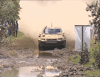 Rally car taking a mud bath