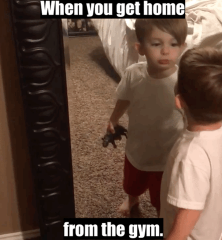 Video gif. A young boy looking himself up-and-down in the mirror, then kissing himself. Text, "When you get home from the gym."