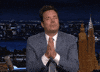 Tonight Show gif. Jimmy Fallon on the Tonight Show has his eyes closed and his hands are in prayer position as he looks both grateful and hopeful. He kisses his hands and sends it out to us.