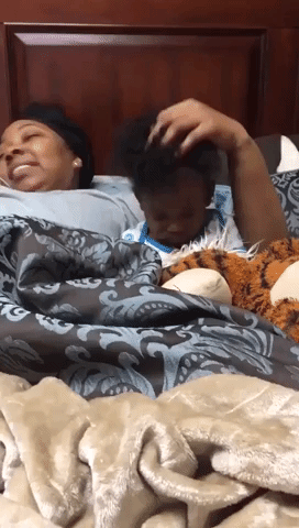 Grandma Helps Drowsy Grandson Fall Asleep