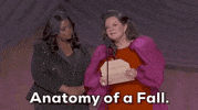 Oscars 2024 GIF. Melissa McCarthy and Octavia Spencer are reading the winner of Best Screenplay. McCarthy wears a red dress with big, puffy magenta sleeves, and Spencer wears a striped sequined black suit. McCarthy holds an open envelope and says, "Anatomy of a Fall" while Spencer's jaw drops next to her. 