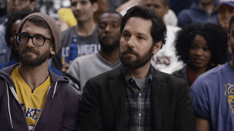 Ad gif. Paul Rudd in a Bud Light Super Bowl commercial is in the audience at a Lakers game and he looks around with confusion, furrowing his brow and glancing around, wondering how he got there.