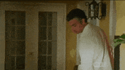 TV gif. Brett Dier and Jaime Camil as Michael Cordero Jr. and Rogelio de la Vega in Jane the Virgin cheerfully greet each other with a special handshake that consists of two high fives and a fist bump ending with an animated "poof."