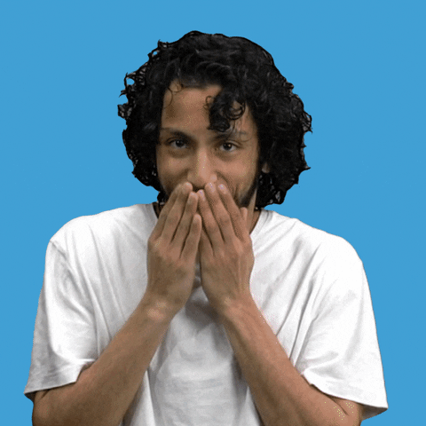 Video gif. Closeup of a man standing in front of a sky blue background as he covers his mouth with both hands and giggles while shifting his eyes around sheepishly. Text, "Hee, hee, hee, hee."