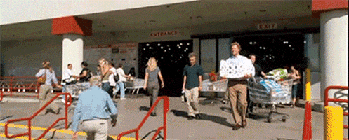Movie gif. Will Ferrell as Brennan Huff in Step Brothers gleefully comes out of Costco holding a bundle of toilet paper. He tucks it underneath his arm so that he can victoriously pump his fist into the air.