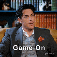 Sponsored gif. Traitors cast member Tom Sandoval turns his head and confidently says, “Game on.” Text also reads, “Game on.”