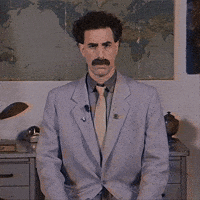 Movie gif. Poor-quality "VHS" footage of Borat staring straight at us and nodding.