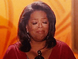 Celebrity gif. Oprah is standing in front of a podium accepting an award, filled with emotion as she closes her eyes, shaking her head in disbelief.