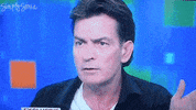 Celebrity gif. Charlie Sheen rolls his eyes and puts his hands up in a dismissive gesture as if to say, “Whatever.”