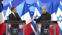 Macron and Netanyahu Shake Hands