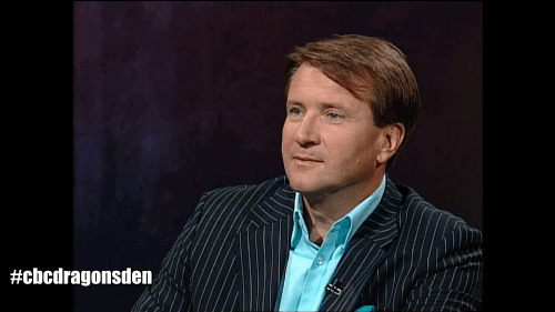 TV gif. Clearly over it, Robert Herjavec on Dragons' Den lowers his hand into his palm.