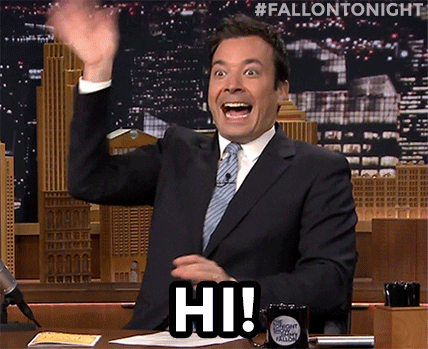 TV gif. On The Tonight Show, host Jimmy Fallon excitedly waves and raises his hands. Text, "Hi!"