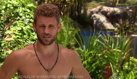 Reality TV gif. A man from Bachelor in Paradise is being interviewed and he scrunches his lips together, cringing.