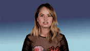 Celebrity gif. Against a blue gradient background, Debby Ryan nods and gestures to us in agreement. Text, "Same" (repeated once).