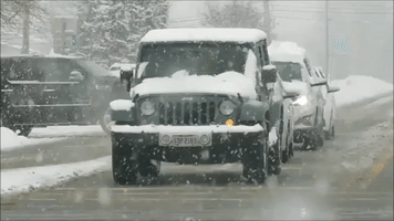 Snow-Covered Cars Navigate Winter Weather in Rochester, New York