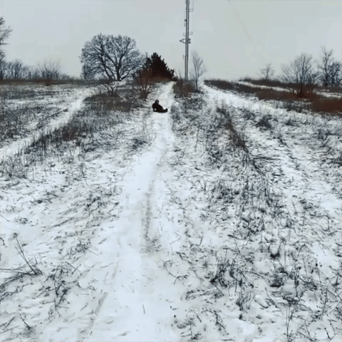 Woman Slides Into 2021 Down Snow Covered Hill in Grand Rapids, Michigan