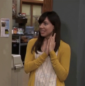 Parks and Recreation gif. Aubrey Plaza as April on Parks and Recreation has a fake smile on her face as she holds her hands up close to her face and claps very small claps. She quietly says, Yay.”