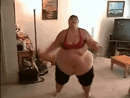 Video gif. A higher weight woman in workout clothes does jumping jacks in her living room.