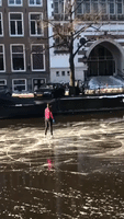 Figure Skaters Glide Across Frozen Amsterdam Canal