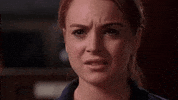 Movie gif. Lindsay Lohan as Cady Heron in Mean Girls grimaces with restrained chagrin.