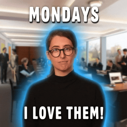 Video gif. Woman glowing blue against a stock image of an office smiles at us and mouths, "Mondays, I love them!" which appears as text.