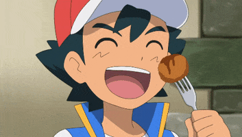 Anime gif. Ash Ketchum from Pokémon has his eyes closed as he brings a piece of food on a fork up to his face. He chomps down on the food happily.